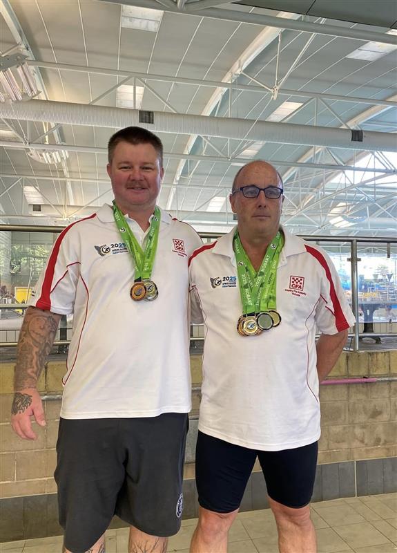 Jeremy and Anthony with their medals from swimming